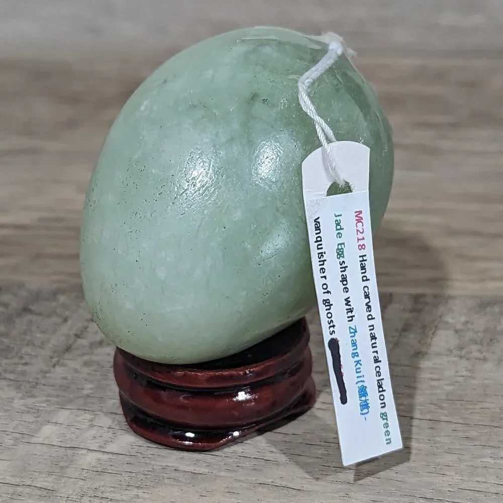 Hand carved natural green jade egg with Zhong Kui with wooden stand